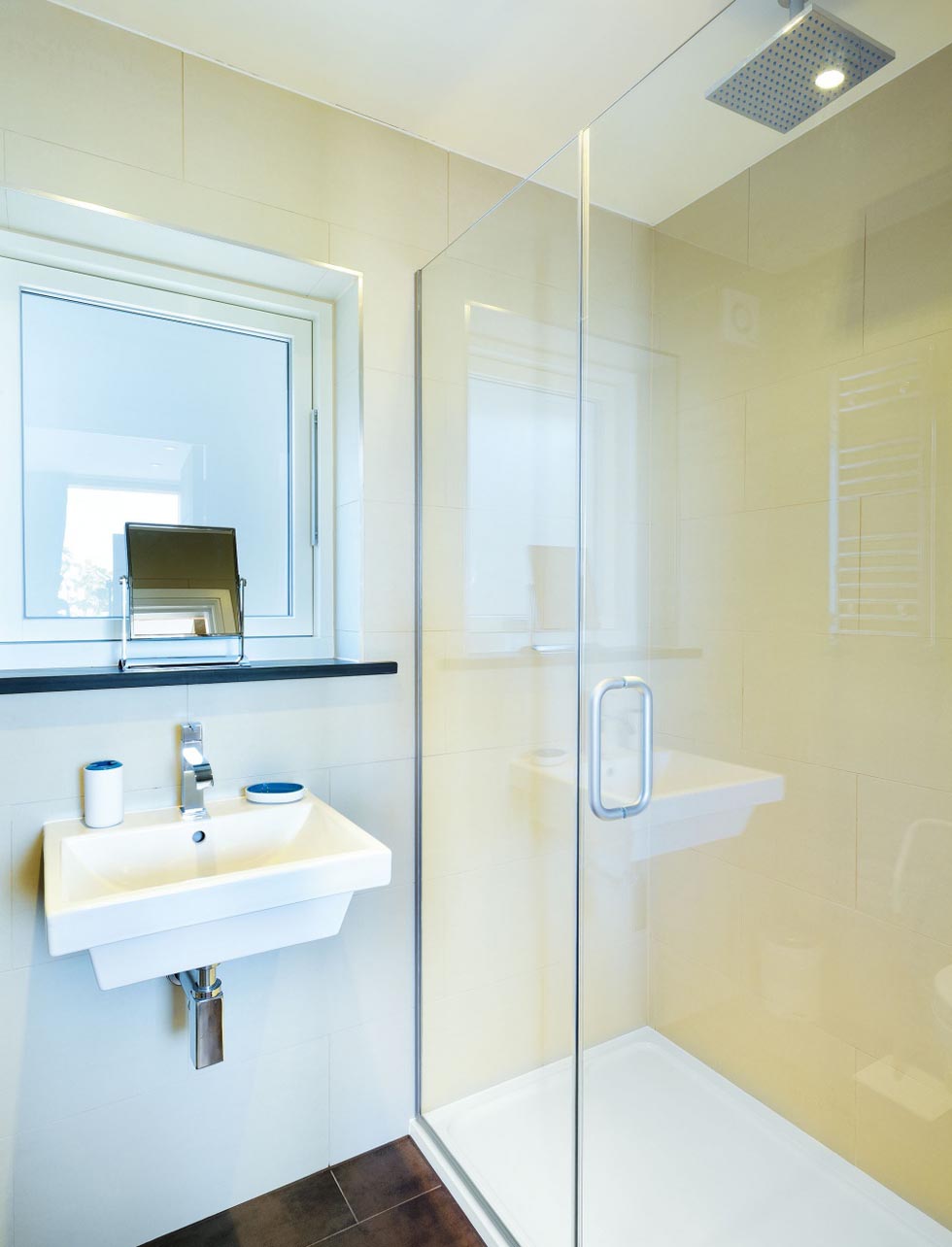 The two en suite bathrooms in the chalet are fitted out with porcelain tiles and sanitaryware from Bathstore