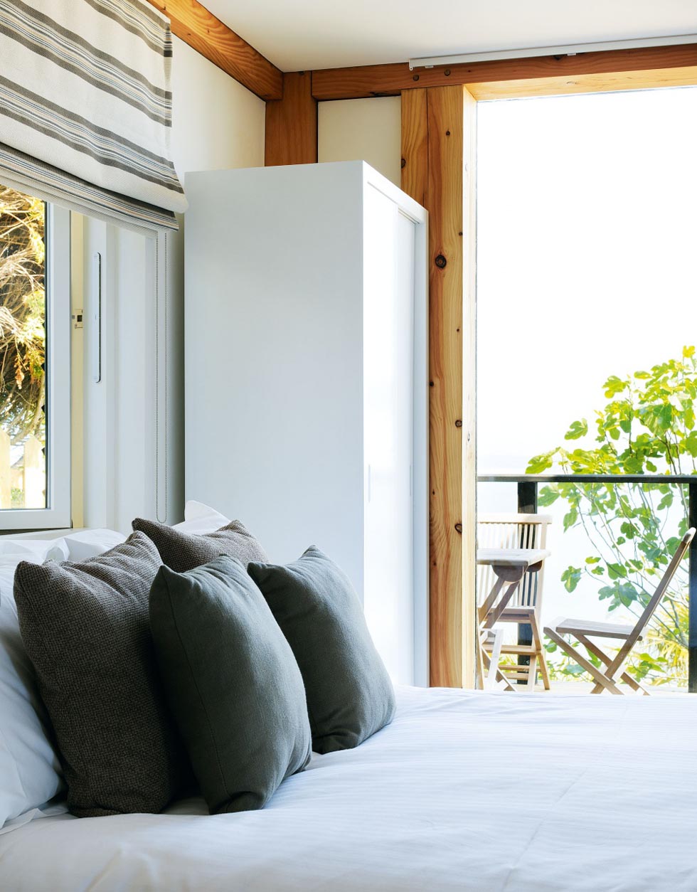 White walls and neutral finishes brighten the bedrooms on the ground floor