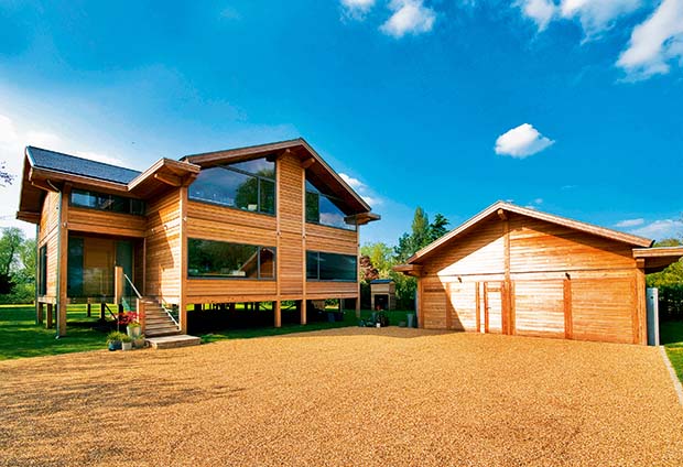 Front elevation of a riverside home on timber posts with a garage which raises on mechanical screw jacks
