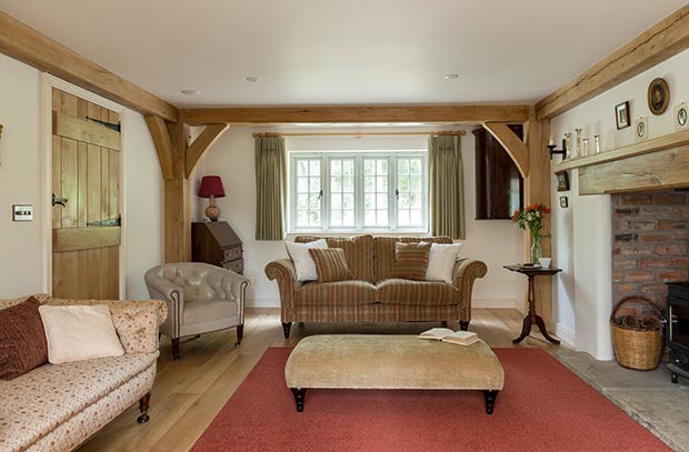 Exposed beams and traditional furnishings in a cottage style living room