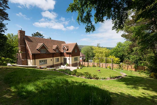 Sloping site home in Shropshire with three storeys and a large landscaped garden