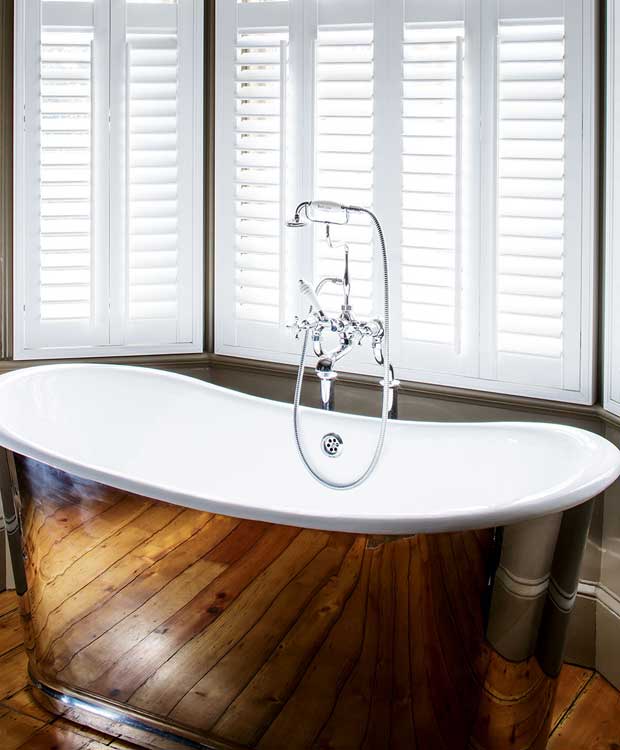 A copper freestanding bathtub