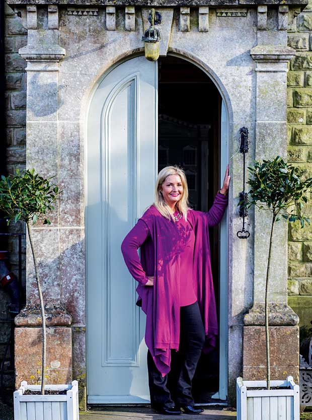 Homeowner Julia Dempster stands in front of the entrance to her Victorian country house