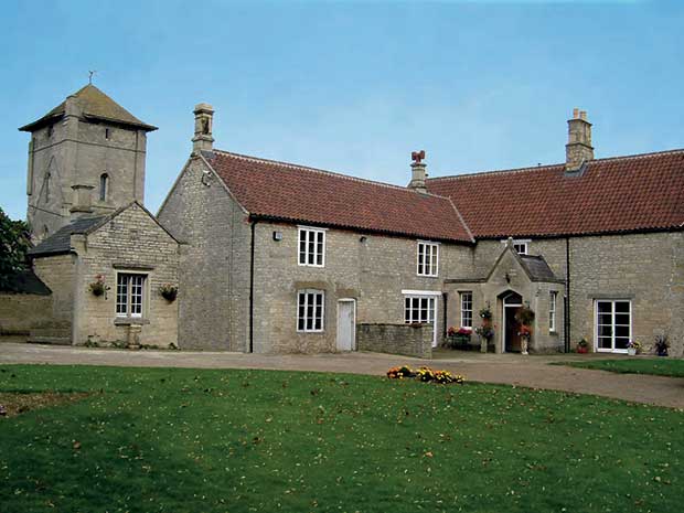 A stone house in a village of old homes