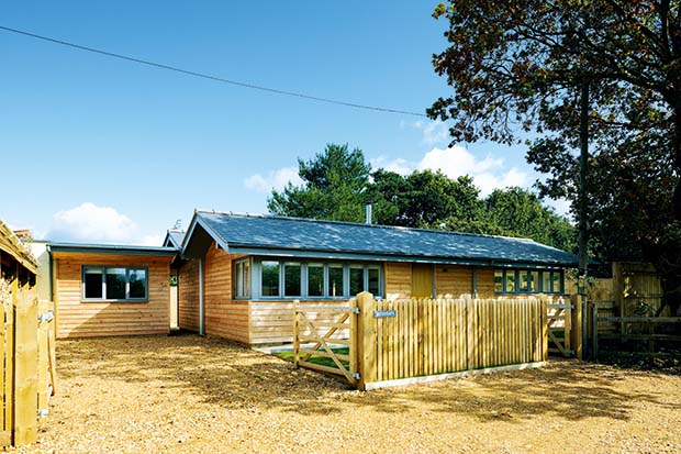 Single storey log cabin in the New Forest clad with Siberian Larch