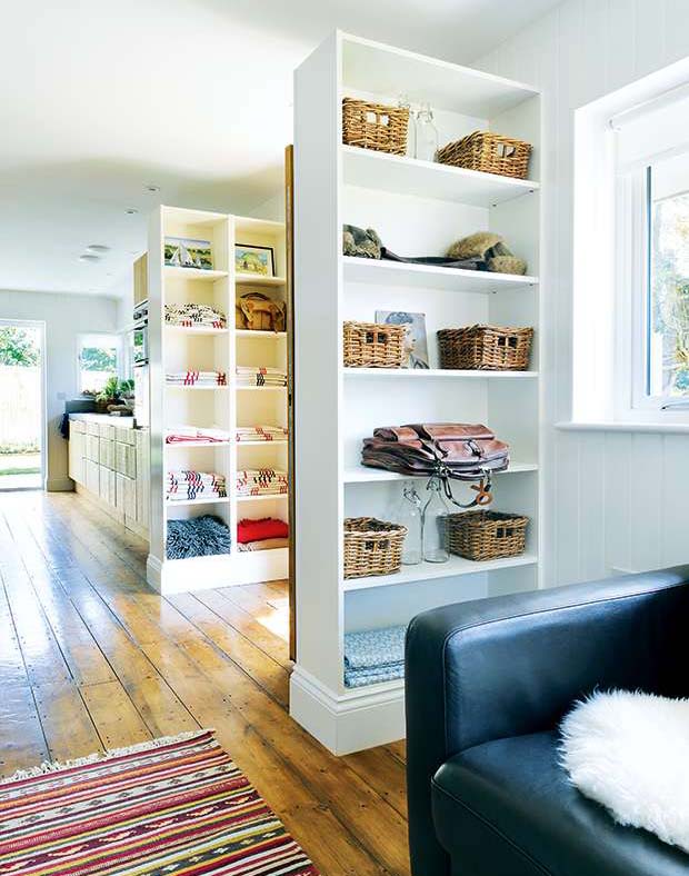 The door sits between customised Ikea Billy bookcases to section off the main living space
