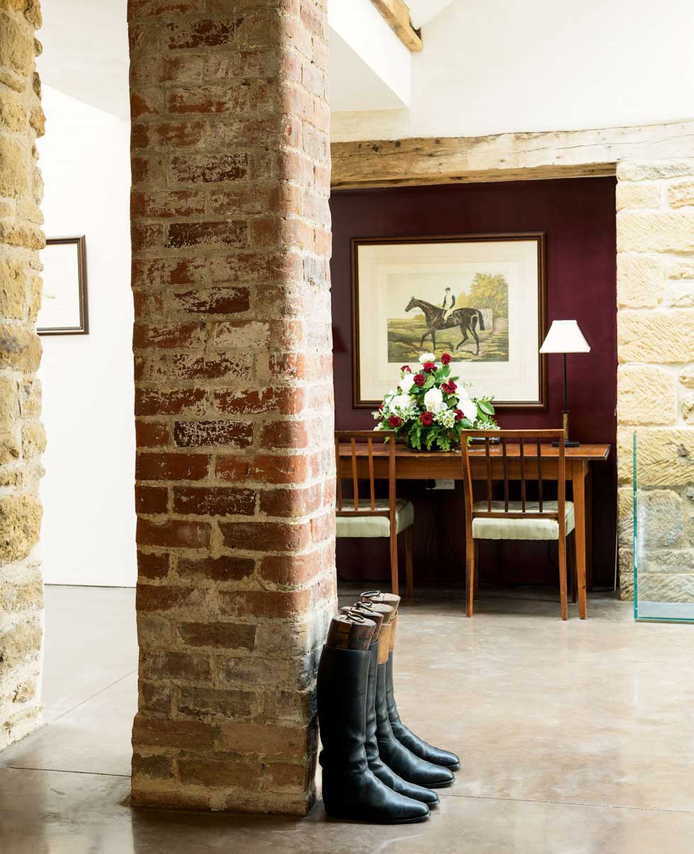 An exposed brick pillar in the open plan dining hall