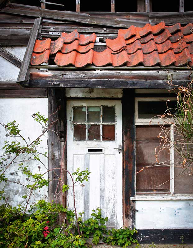 A decaying timber door and door frame