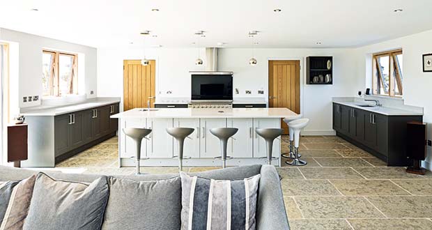 Open plan kitchen in a barn style clad SIPs home