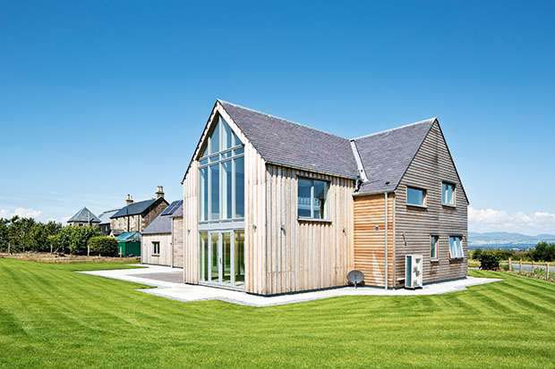 Siberian larch clad SIPs home with double height windows