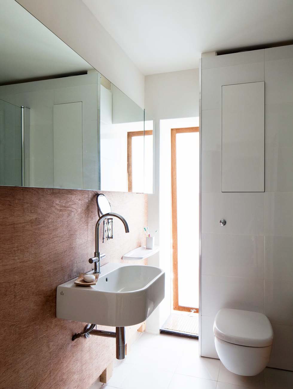 Frosted slot windows in the bathroom draw in plenty of light but offer maximum privacy