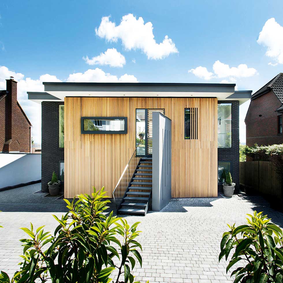 The front of the house is clad in cedar boarding