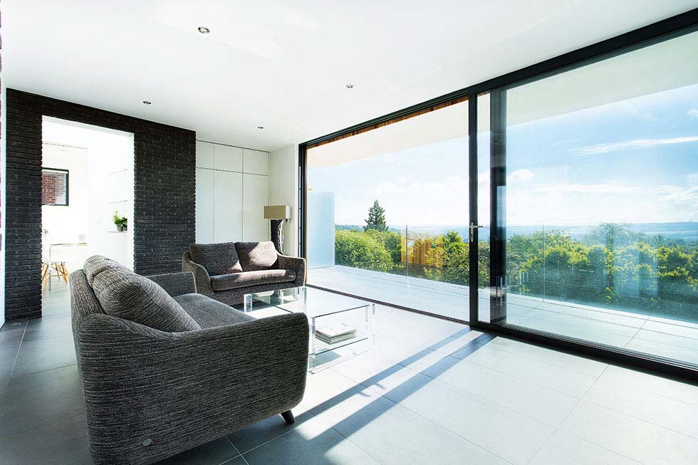 The first floor living room opens onto a balcony through sliding glass doors