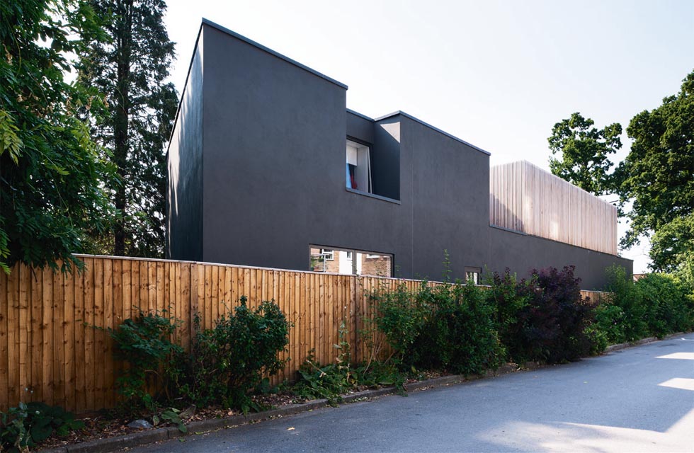 The rear elevation, which faces a private road and a three storey flat development, features minimal windows. A large recess punctuates this elevation at first floor level, enabling a window opening to be introduced, without impeding on privacy.