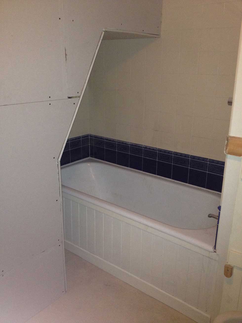 bath surrounded by plasterboard