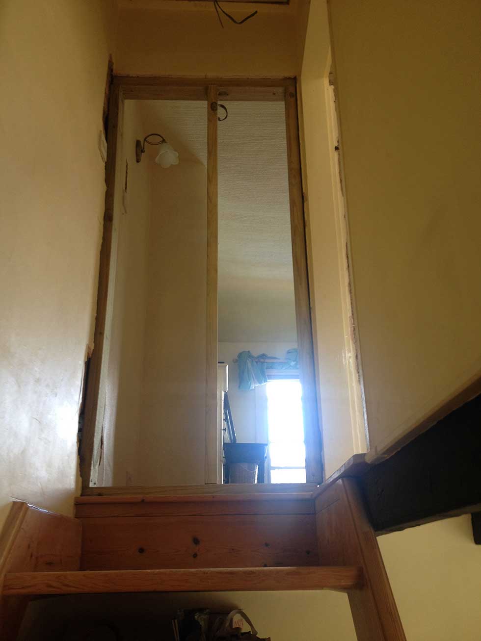 stud wall from bottom of stairs in old doorway