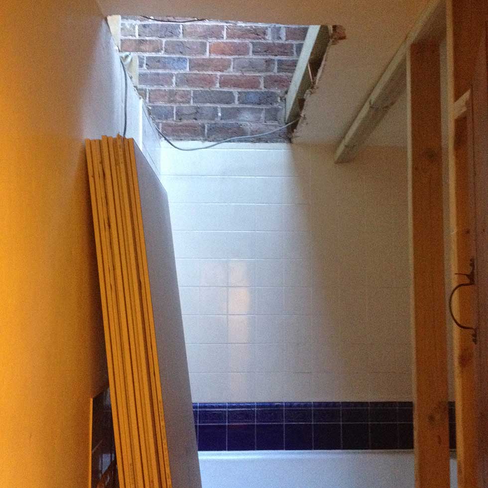 hole in bathroom ceiling above bath to loft