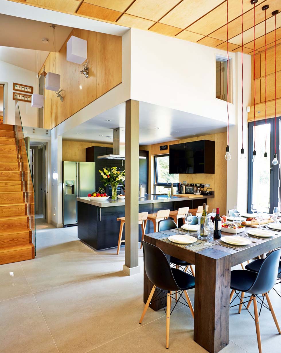 The hallway opens into a large room zoned for cooking, eating and relaxing