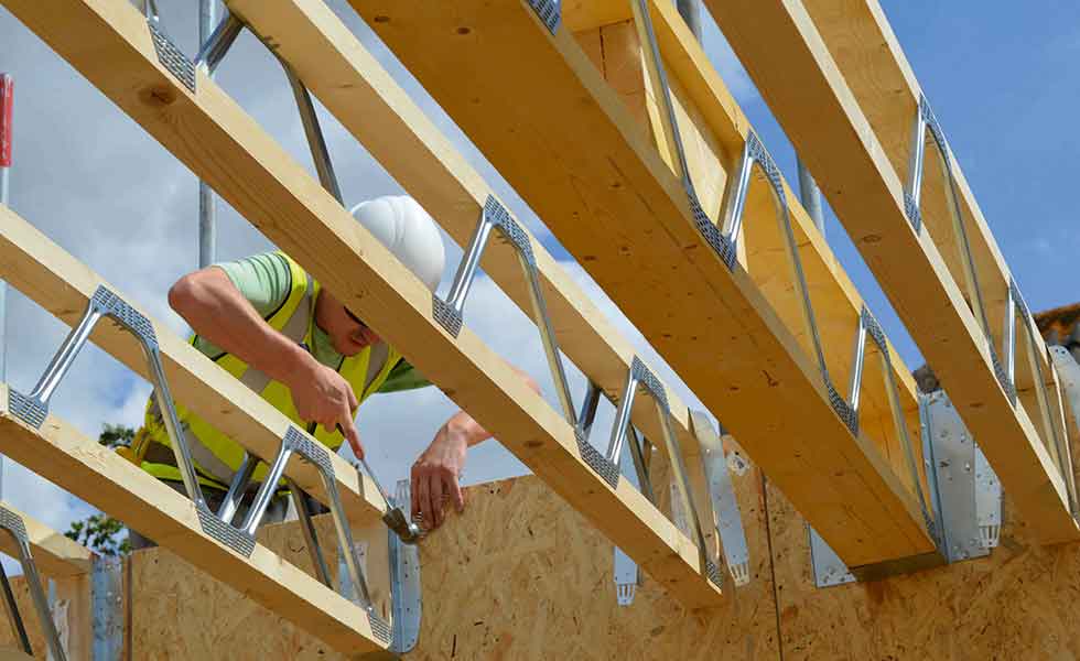 man checking joists for first floor