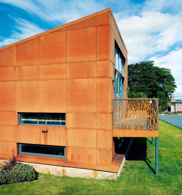 Exterior of the converted farm building with an extension in Cor-ten steel