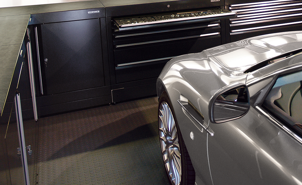 expensive car in a garage with base units and PVC floor tiles