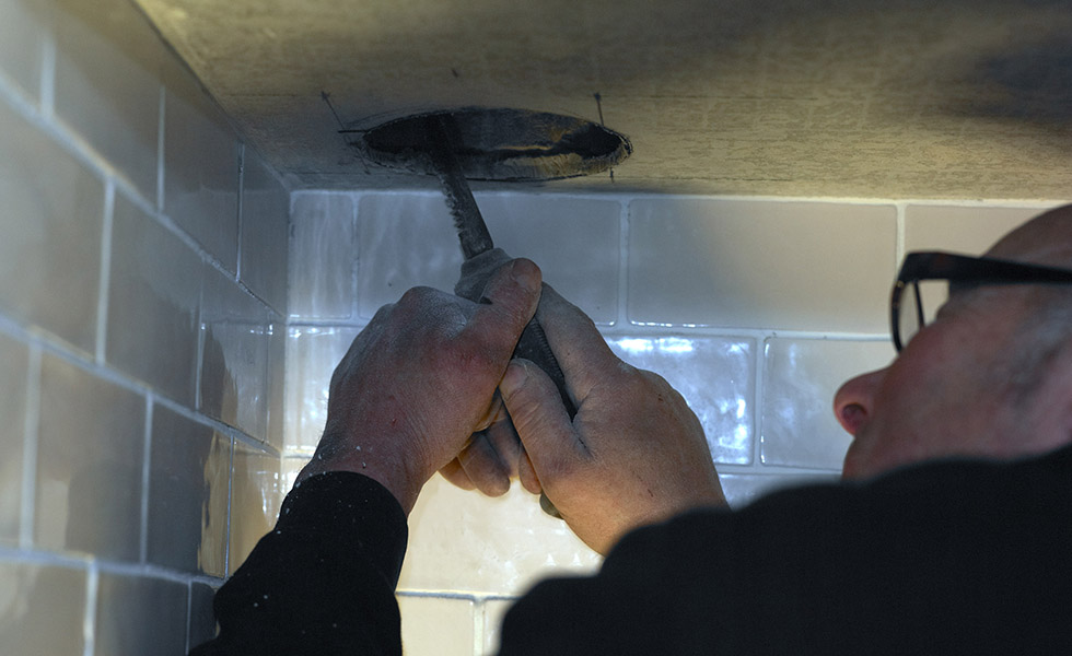 cutting a hole for the flue for the range cooker