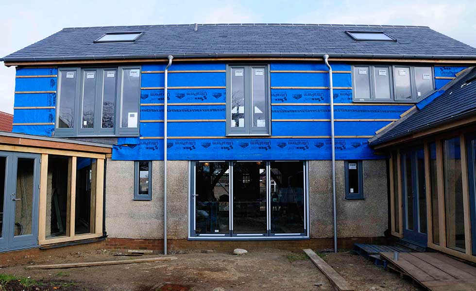 bi-fold doors and a juliet balcony and casement windows on oak frame self build