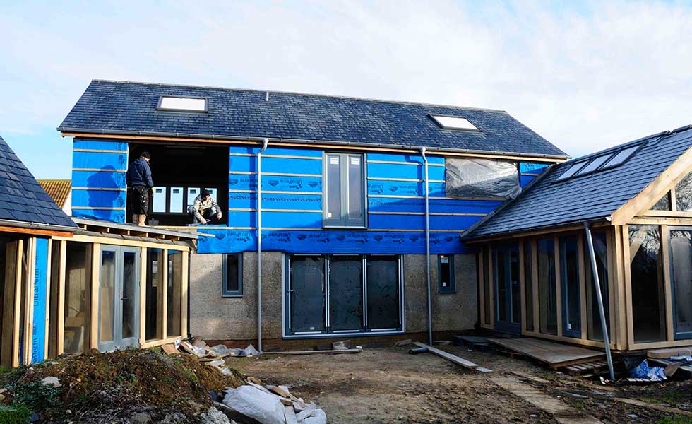 team installing windows on an oak frame home