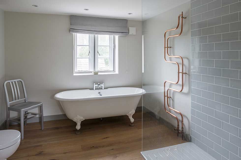 listed cottage renovation bathroom with copper pipes
