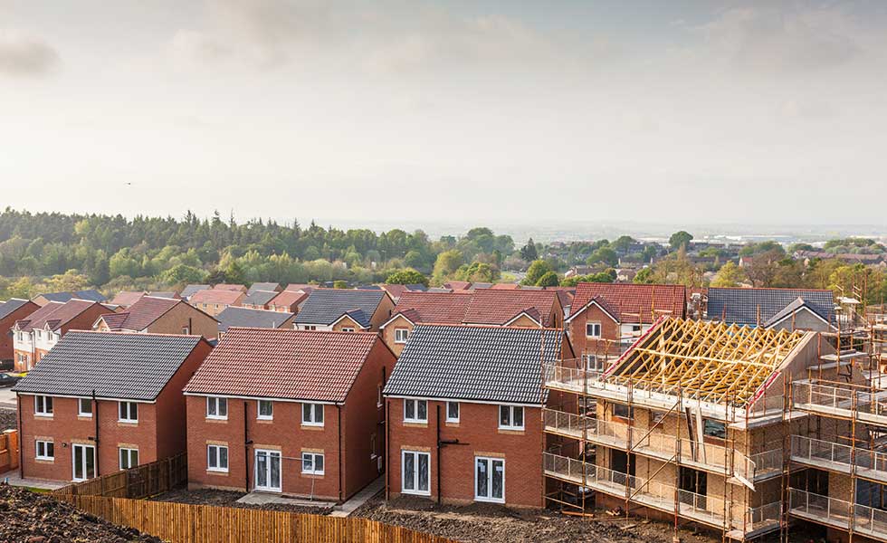a housing development built in simple form to minimise costs