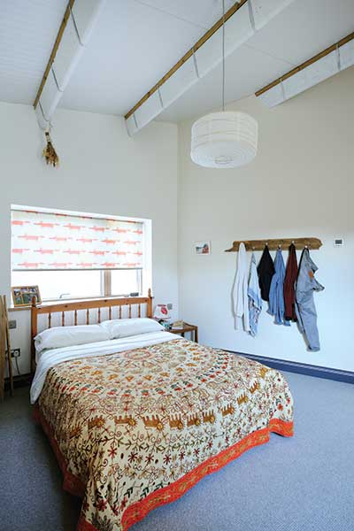 bedroom with exposed roof joists