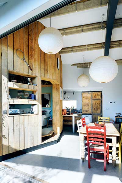 dining area with wood clad living room area