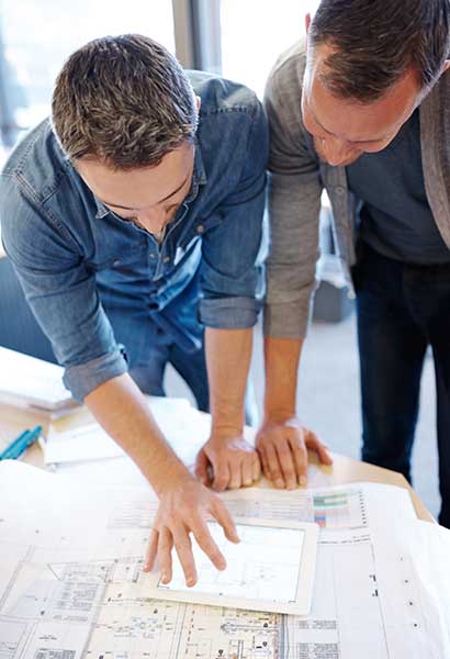 man and his architect looking at house designs