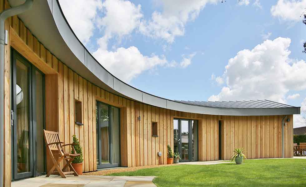A curved timber-clad Passivhaus