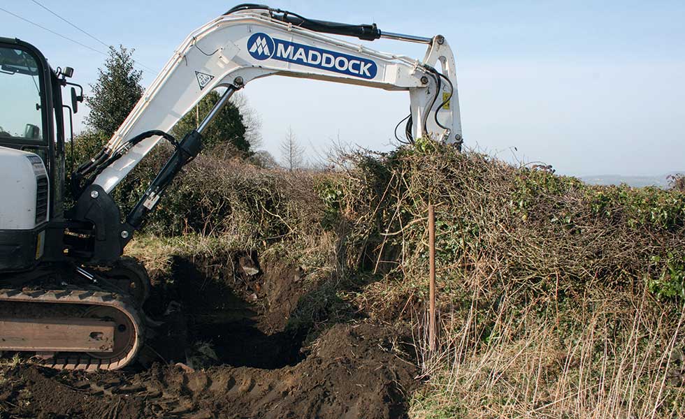 Digger clearing building plot