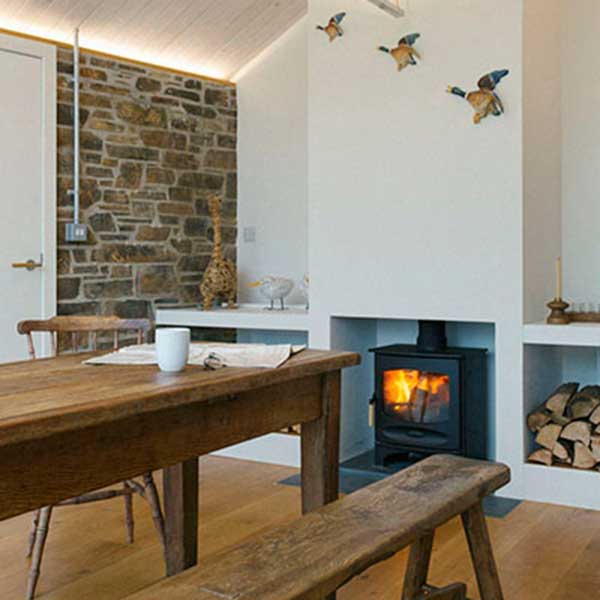 cottage dining room with oak table and log burner