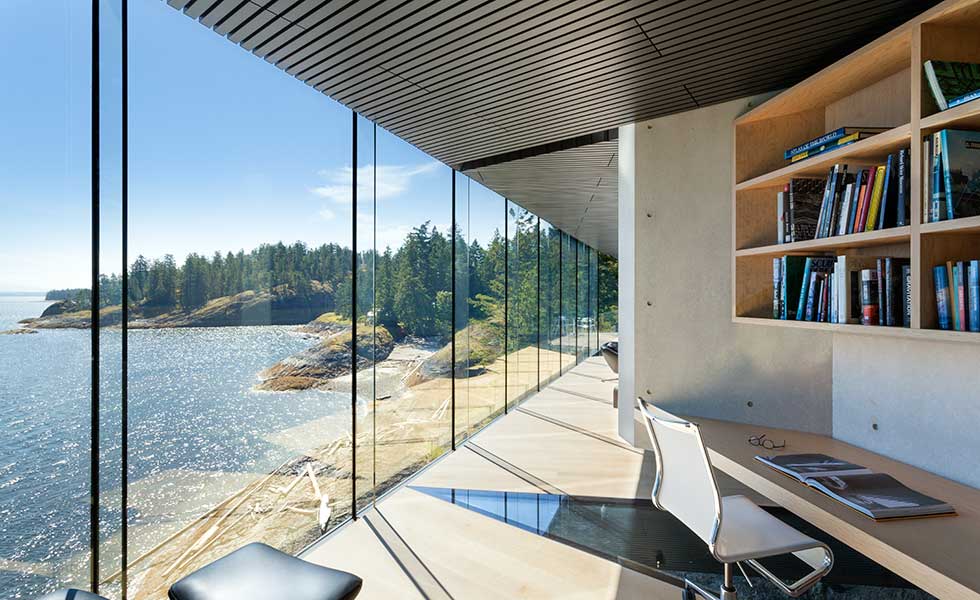 view out of glass windows across lake from office space