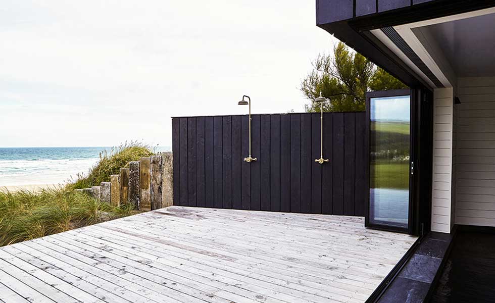 beachside outside shower space with black panelling