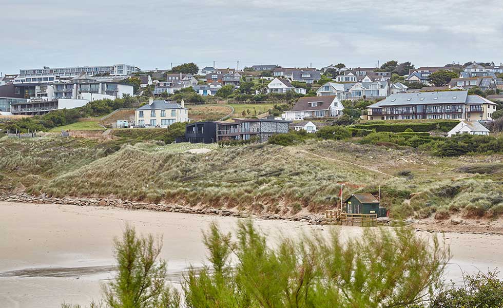view of beach and contemporary home in the sand dunes