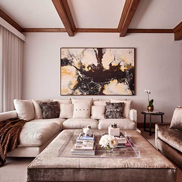 beige and brown living space with velvet sofas