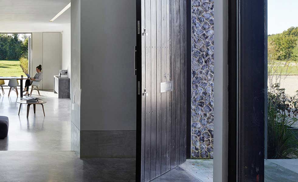 front door of modern home showcasing open plan inside and stone finish