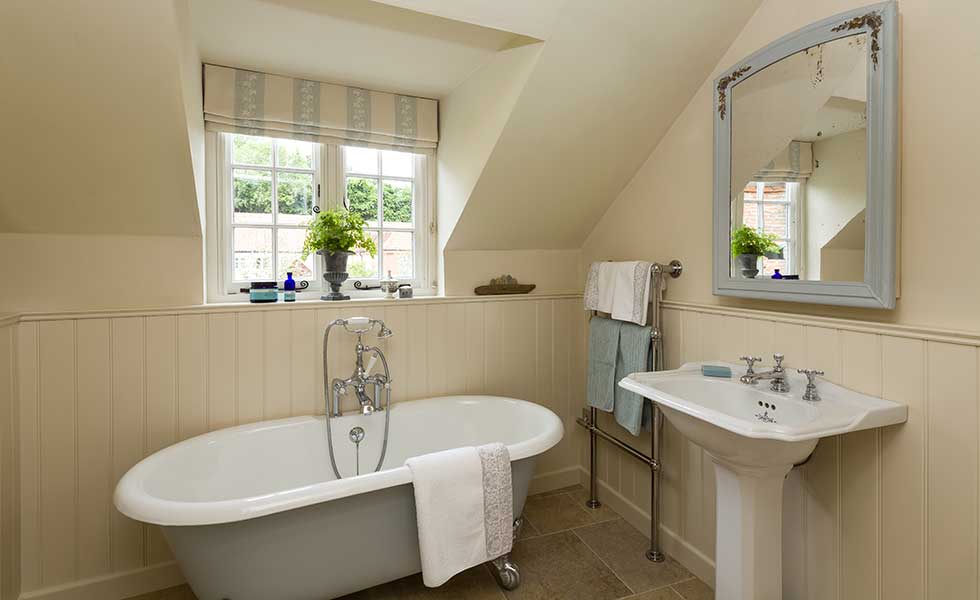 country style bathroom with olive green freestanding bath