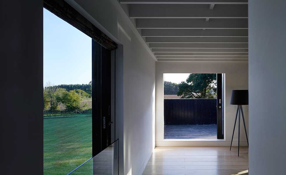 double sliding doors in modern home overlooking garden space of open plan living room