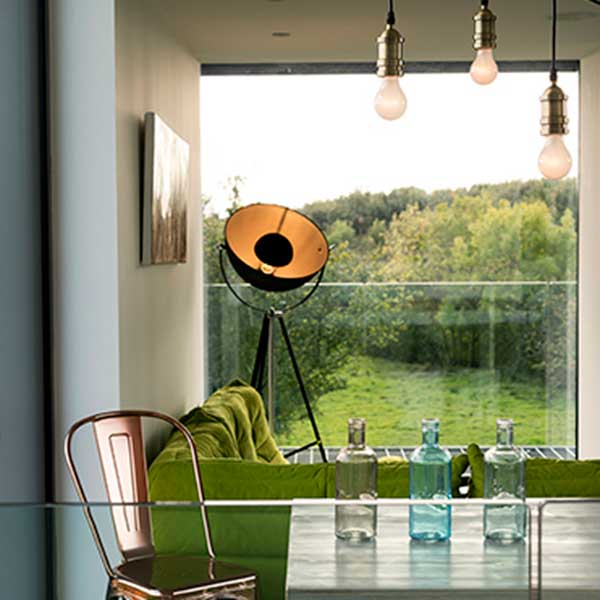 living space overlooking green country space with light green sofa