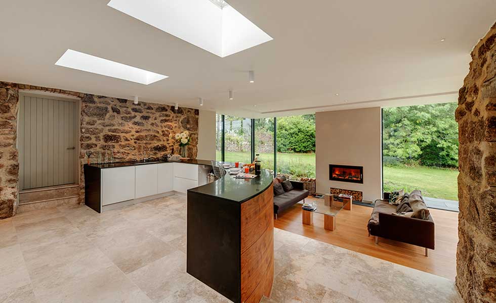 open plan living and dining space with exposed wall