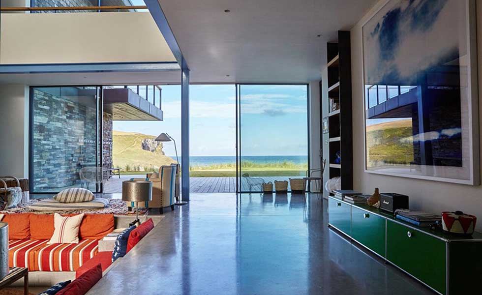 open plan living space with glass sliding doors overlooking sea view