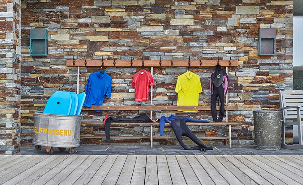 outside changing area with space to hand wetsuits and store surfboards
