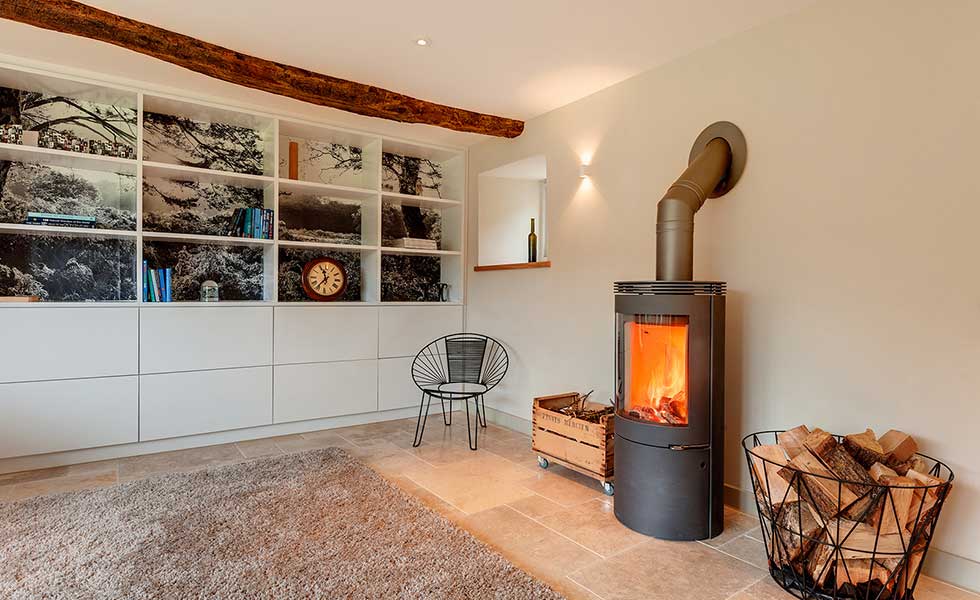 room with log burner and storage
