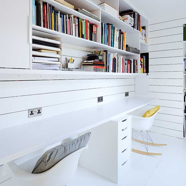 scandi style office space with rocking chairs, white desks and bookshelves