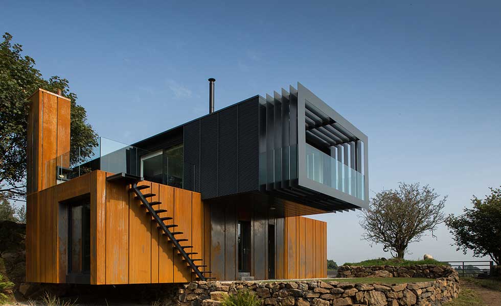 side shot of shipping container home with balcony extending